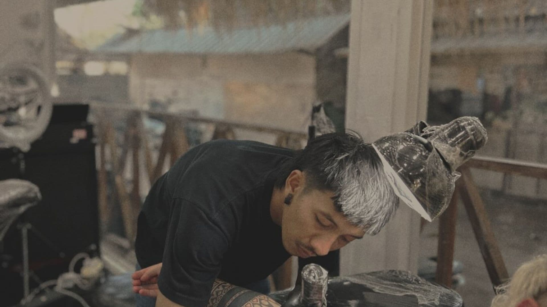 MG tattooing a client in the studio