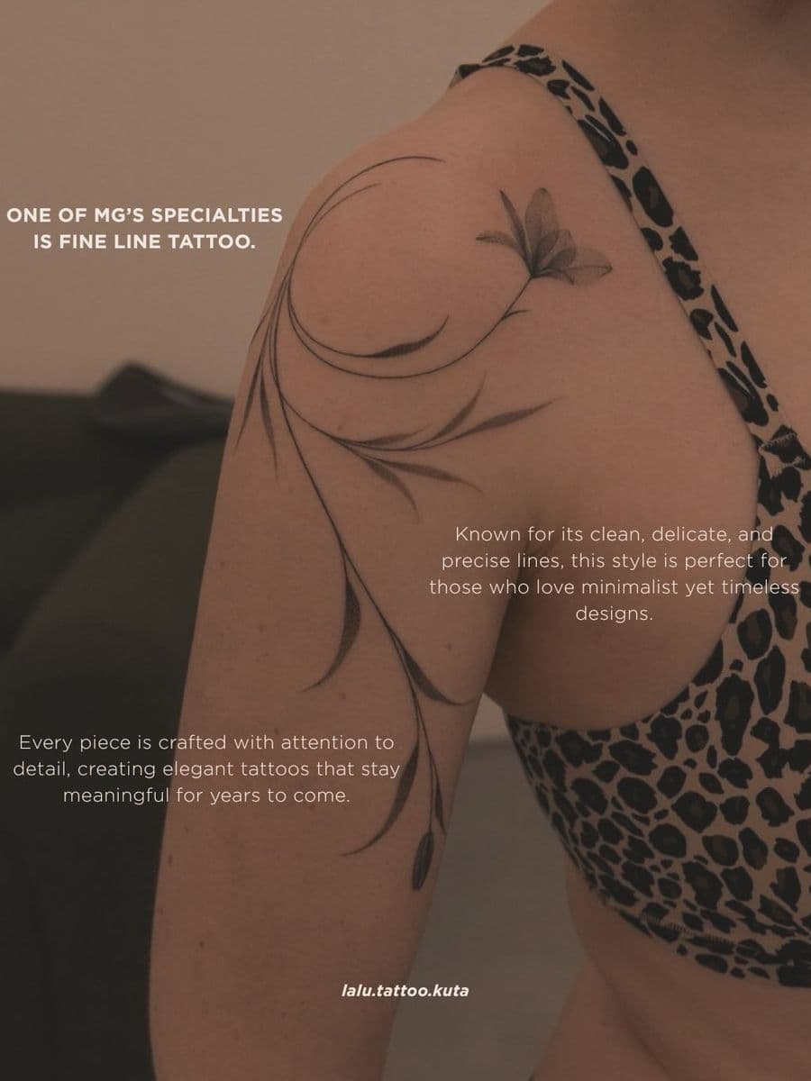Fine line floral tattoo on a shoulder