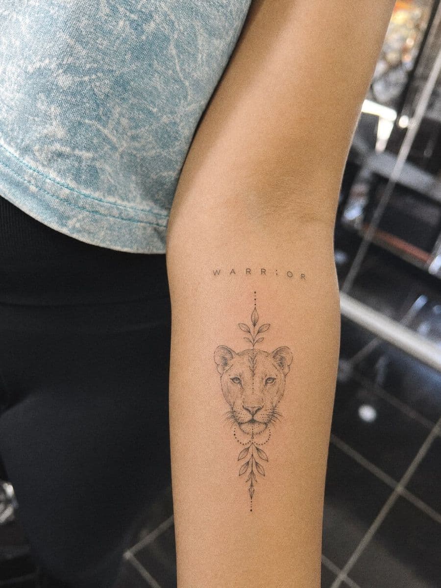 Fine line lioness tattoo on a forearm